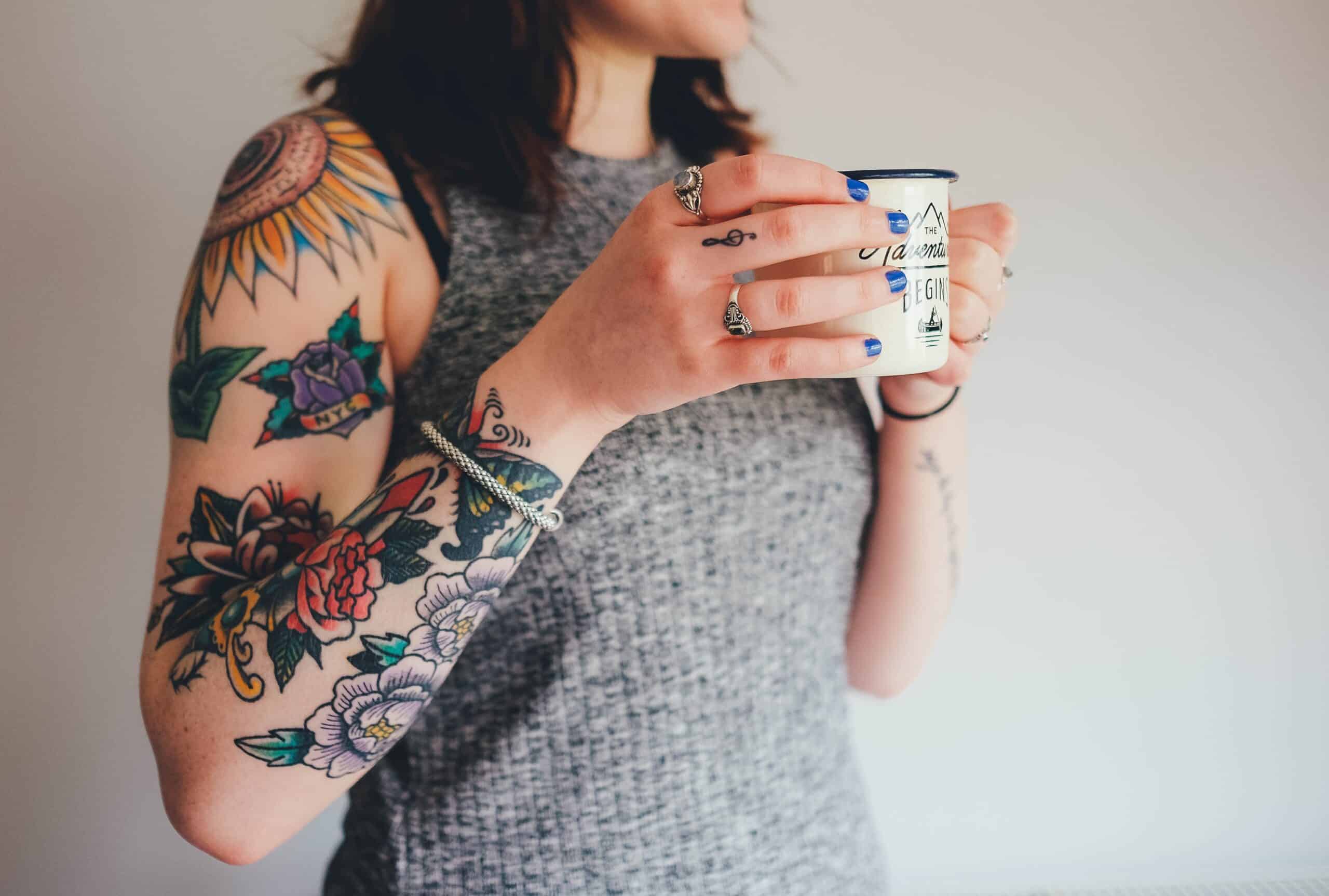 Women showing her arm tattoos