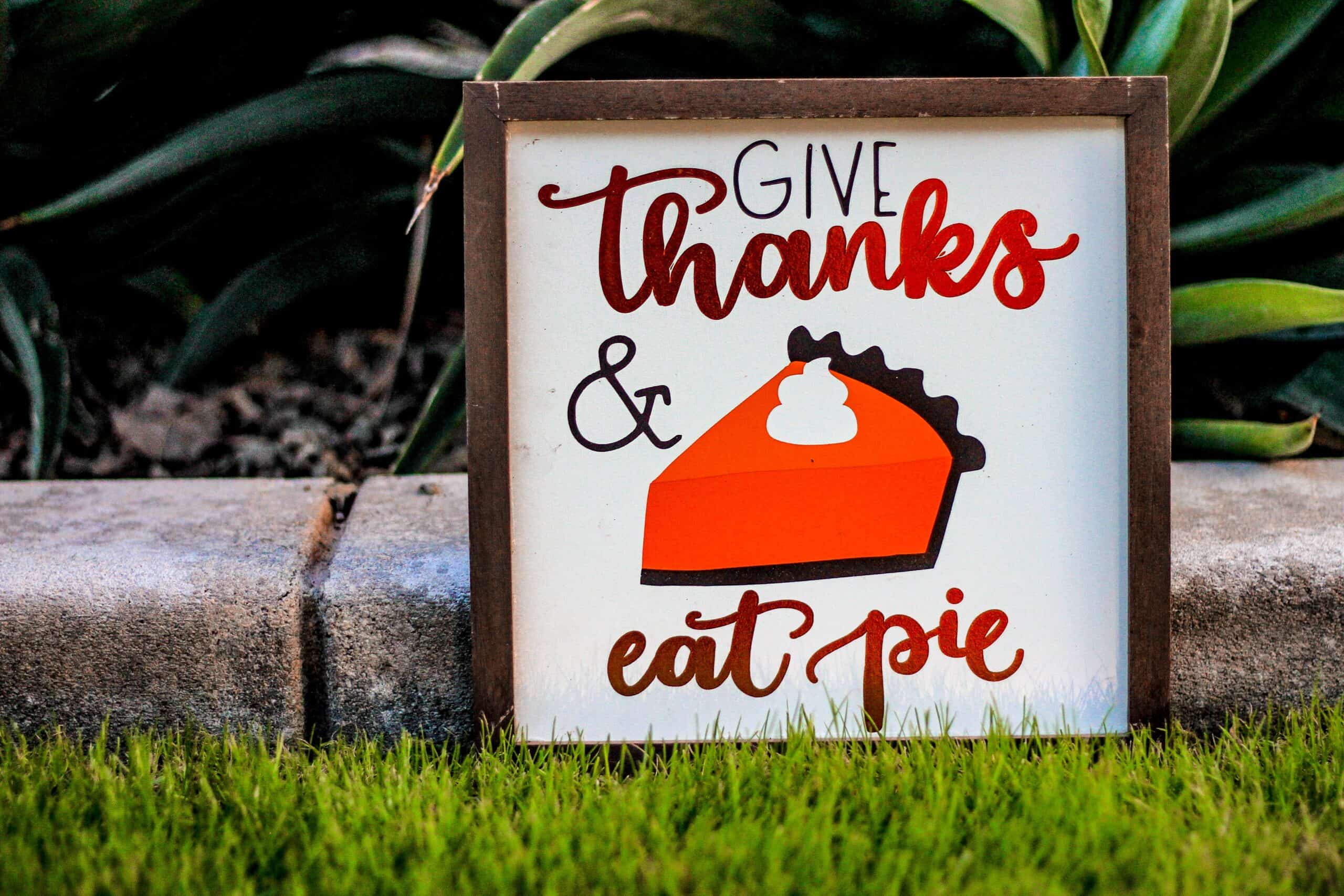 Yard sign that reads "give thanks & eat pie"