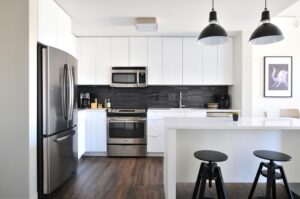 White home kitchen with silver and black appliances