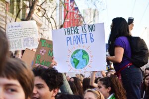 Climate change protest with sign that says there is not planet b