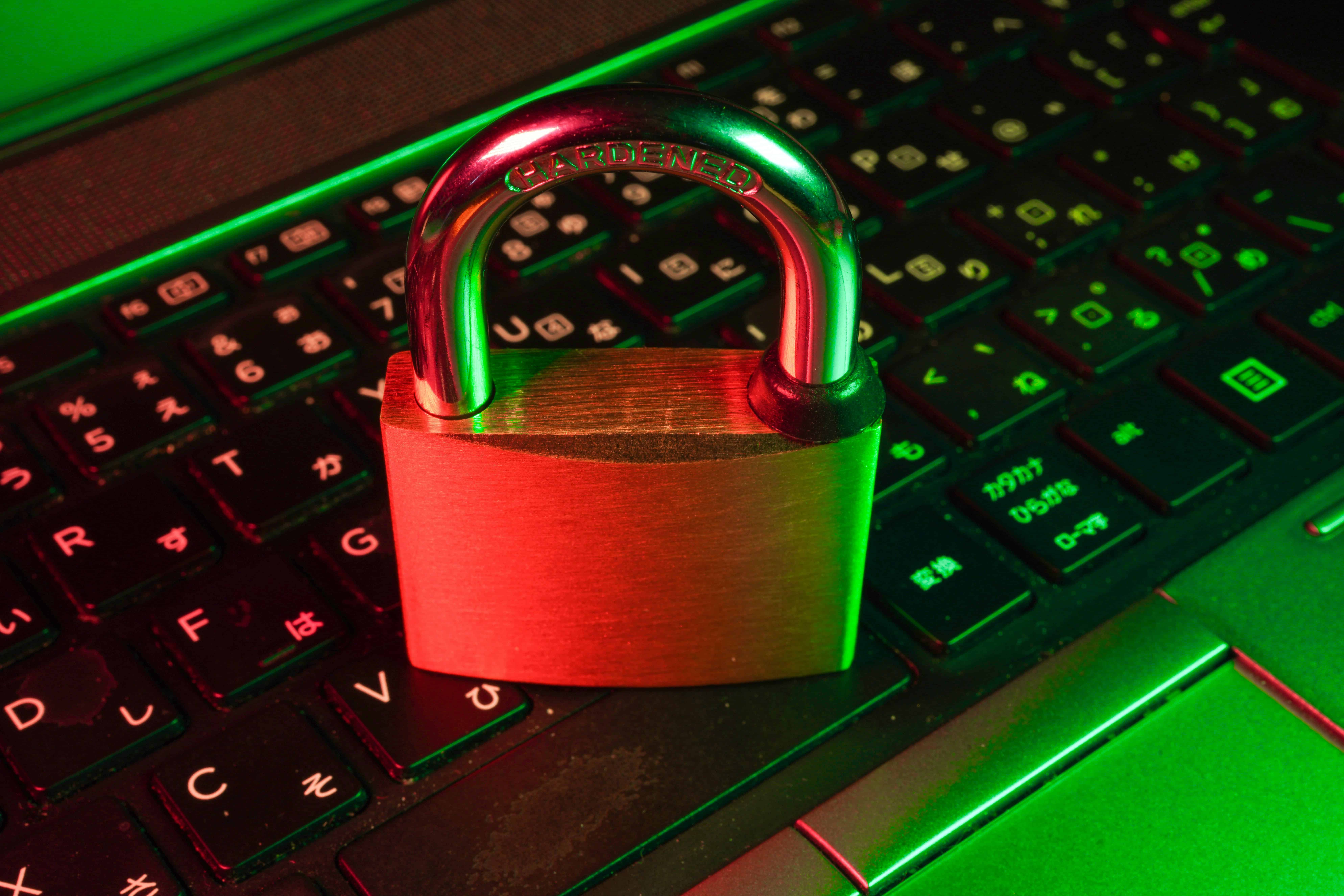 Padlock over keyboard, highlighting cybersecurity