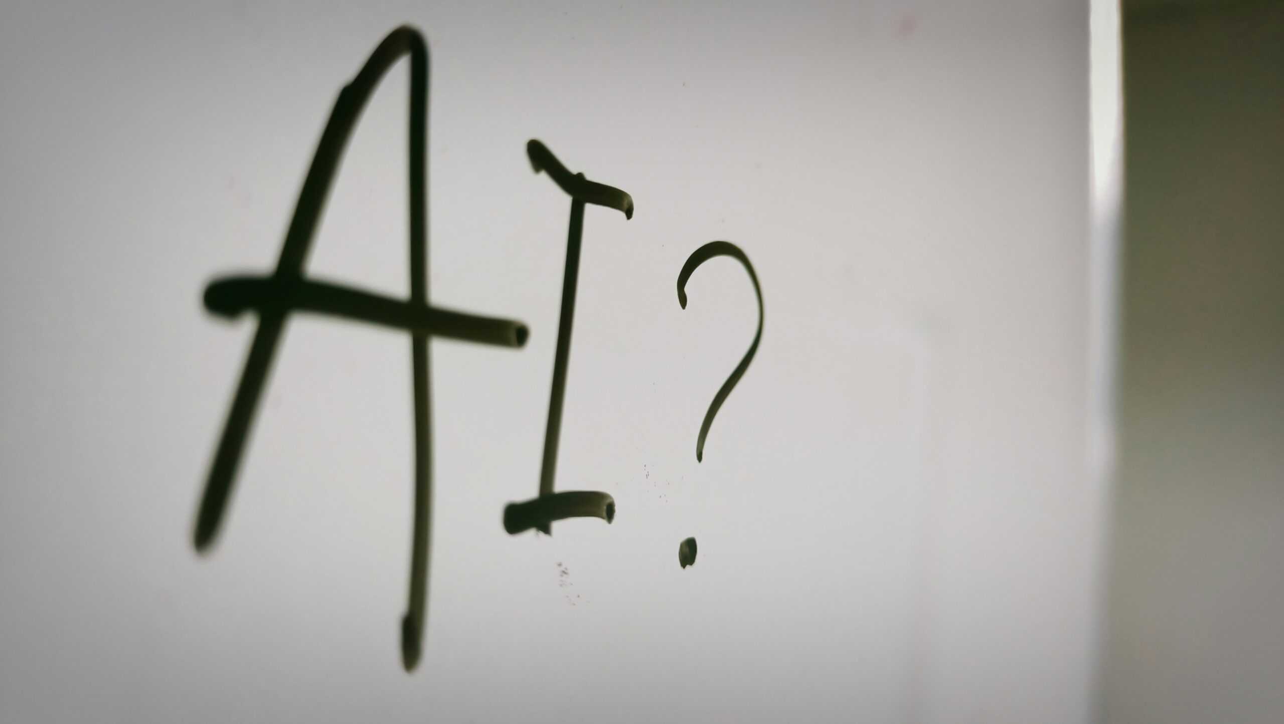 AI? written in black marker on a white board.