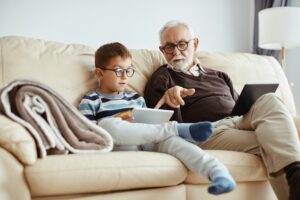 Older man with younger boy on couch