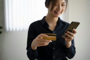 Women holding credit card and mobile phone