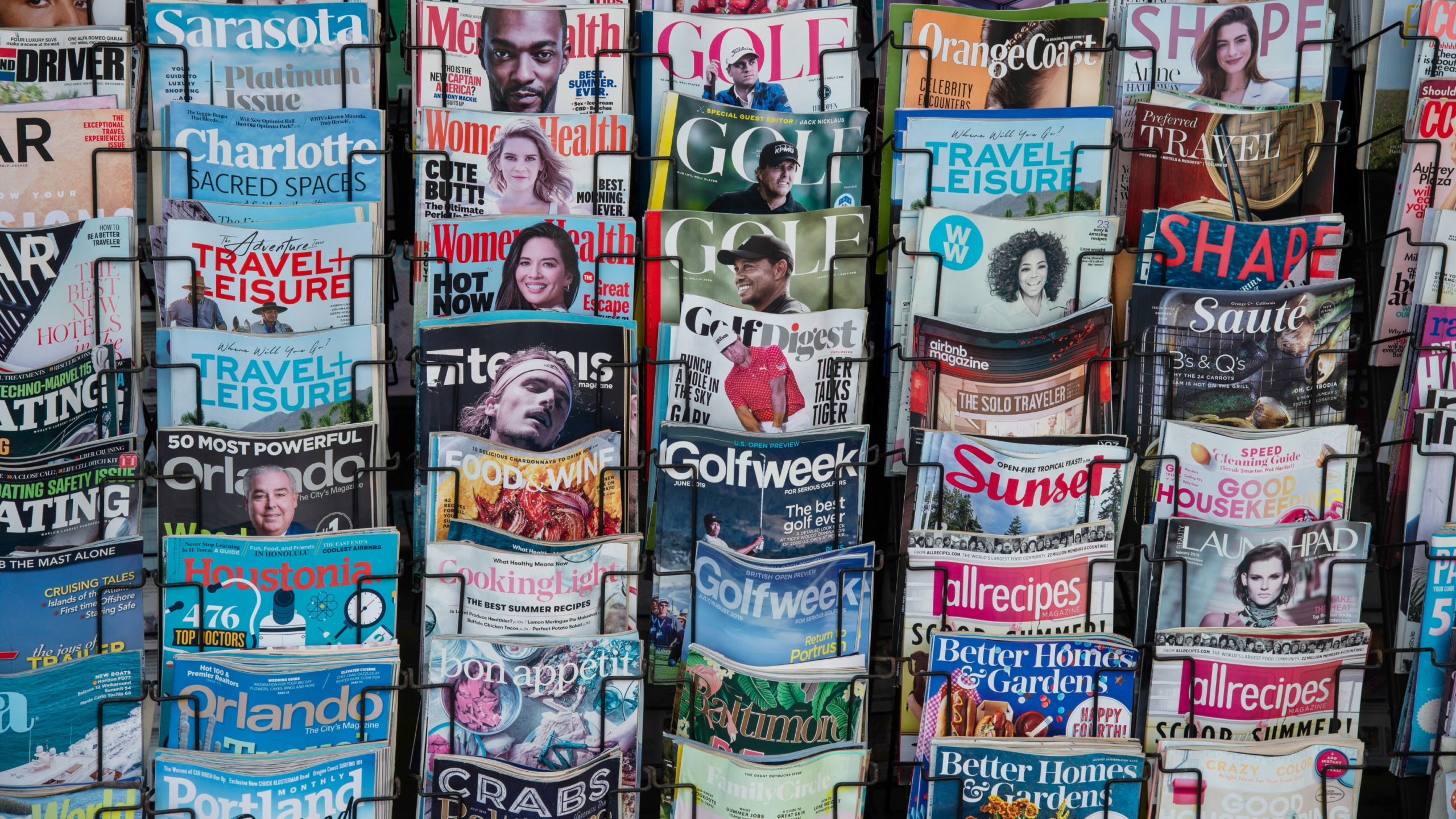 A close up of 5 vertical racks of magazine covers of various topics such as golf, travel, and food